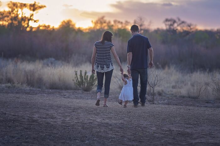 social etiquette rules - couple walking in the desert with their child