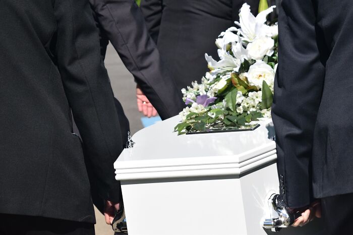 social etiquette rules - people carrying a casket at a funeral