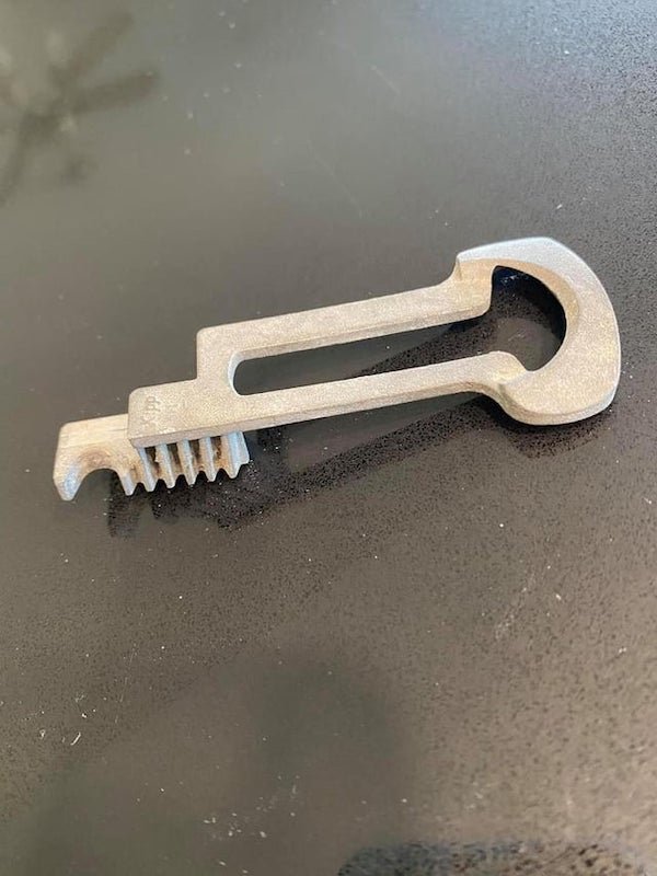 Has ridged teeth, looks almost like a bottle opener on the one end, but is definitely not effective as one. Says KIPP on it.

A: It’s one of these “GM ignition switch actuator” thingies.