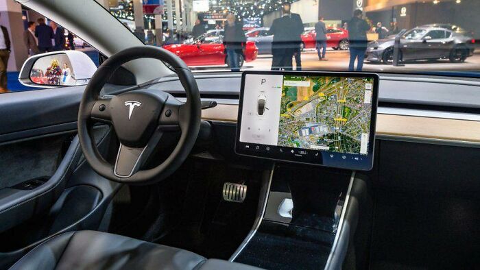 TIL After crashing, a driver in German was fined for using Tesla touchscreen wiper controls, under the same rules as using a phone while driving. The German court decided touchscreen car controls should be treated as a distracting electronic device.