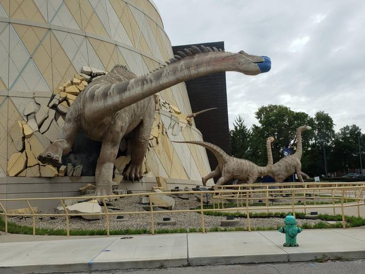 “These dinosaurs wearing masks at the Indianapolis Children's Museum.”