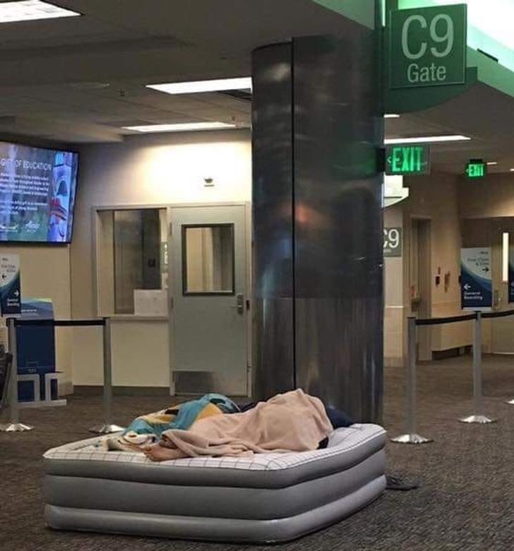 funny airport pics - people sleeping on mattress inside airport
