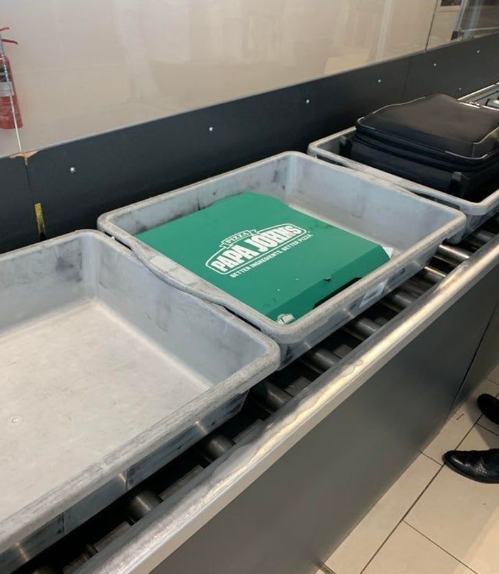 funny airport pics - boxes of pizza going through airport security