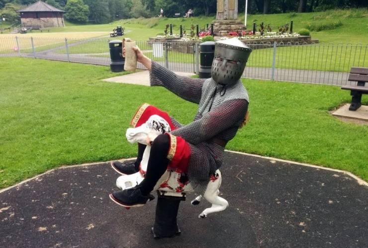 funny pics - dressed as knight riding horse in playground
