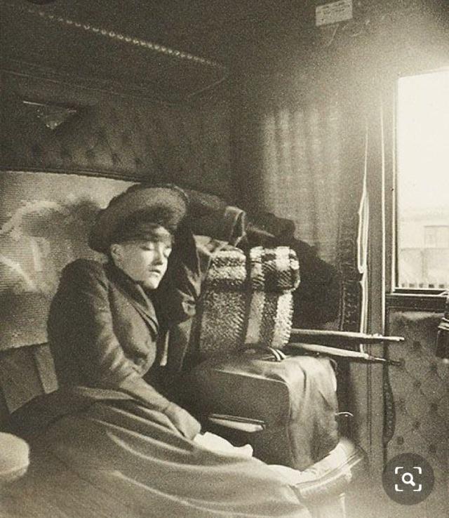 Woman sleeping in a train wagon, 1895