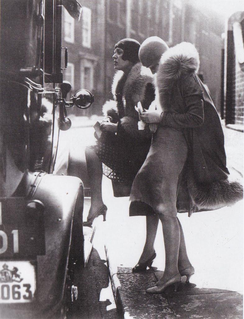 Two women paying their cab fare, London, late 1920s