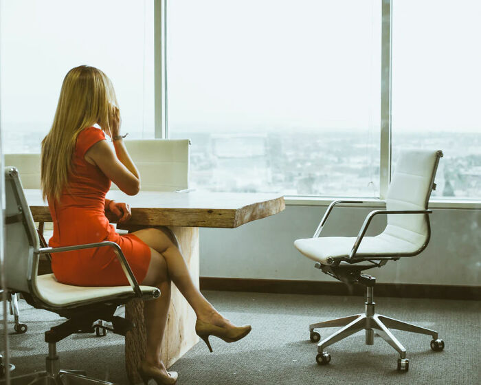 funny work stories -- woman in conference room talking on phone