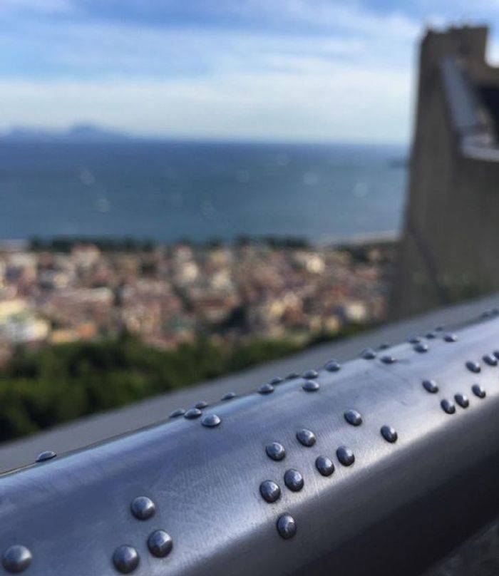 “Handrail in Napels Describes the view in braille.”