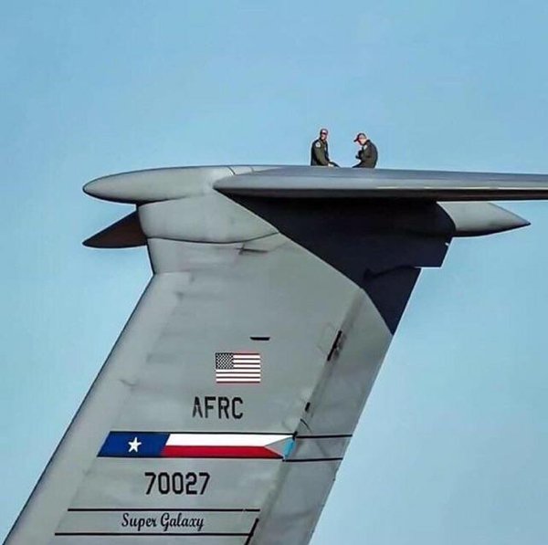 Two mechanics on the C-5 Galaxy transport aircraft.