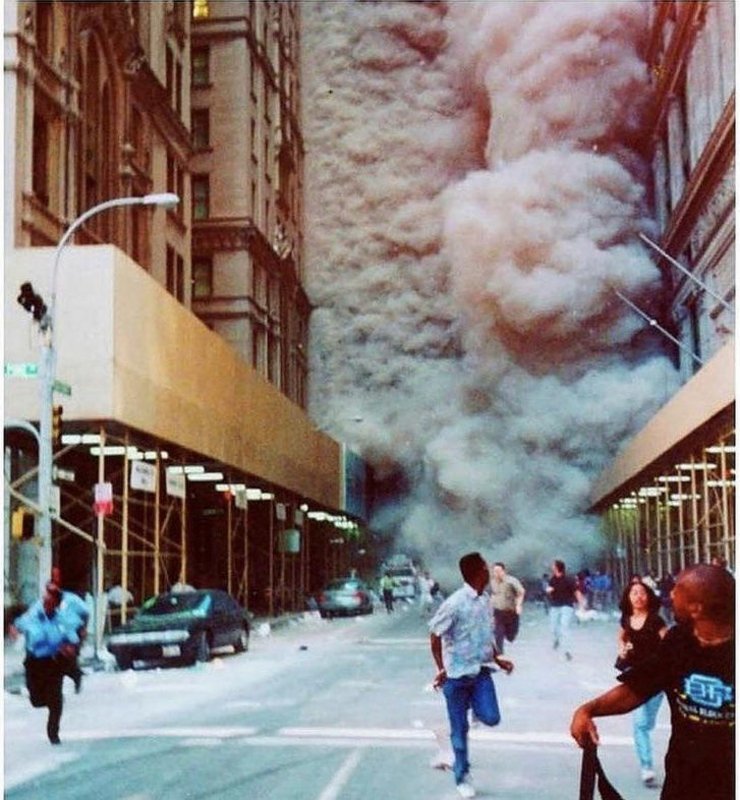 People running as a building collapses on 9/11