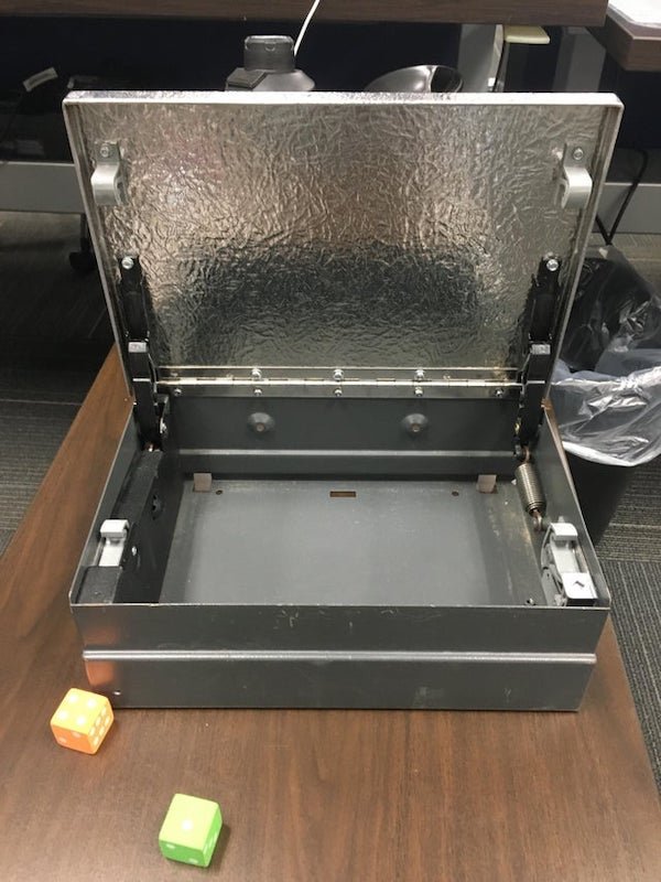 This was shipped to our office with no name or return address. Looks to be an odd lockbox of some sort.

A: It’s a POS cash drawer