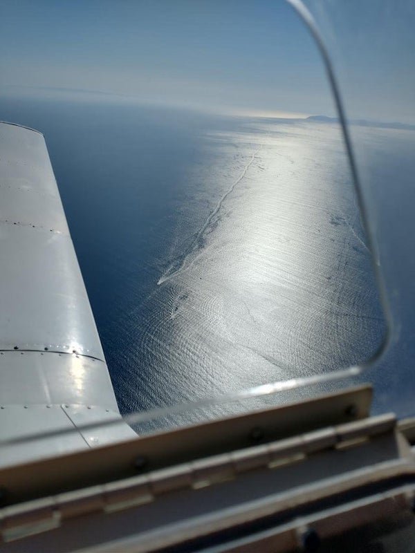 What’s the long-lasting trail behind this boat?

A: The disturbed water hasn’t mixed back into surrounding water very quick and the sun is reflecting off the different surface waves amplifying the difference.