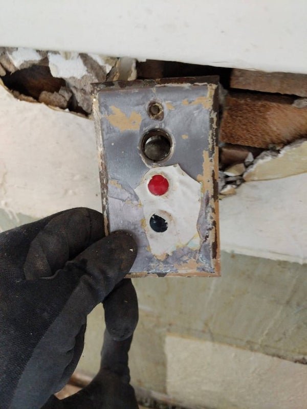 Found plastered over in 100 year old kitchen above sink

A: Switch with indicating light. Possibly to turn on and off a furnace, outdoor light, whatever you might want to monitor it’s state.