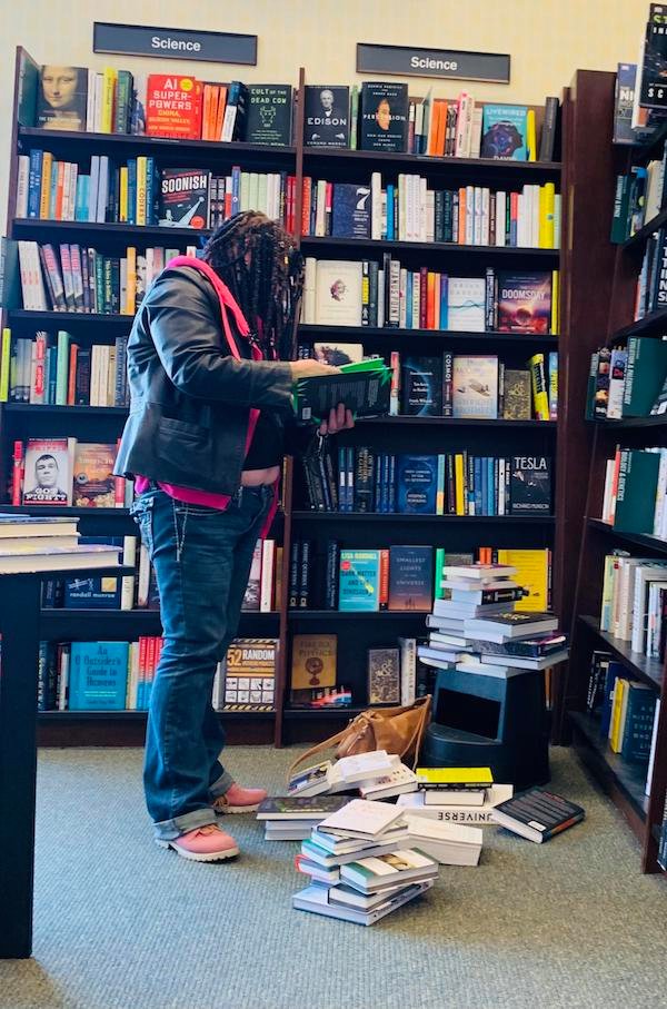 Did she purchase or put back any of the books?…of course not.