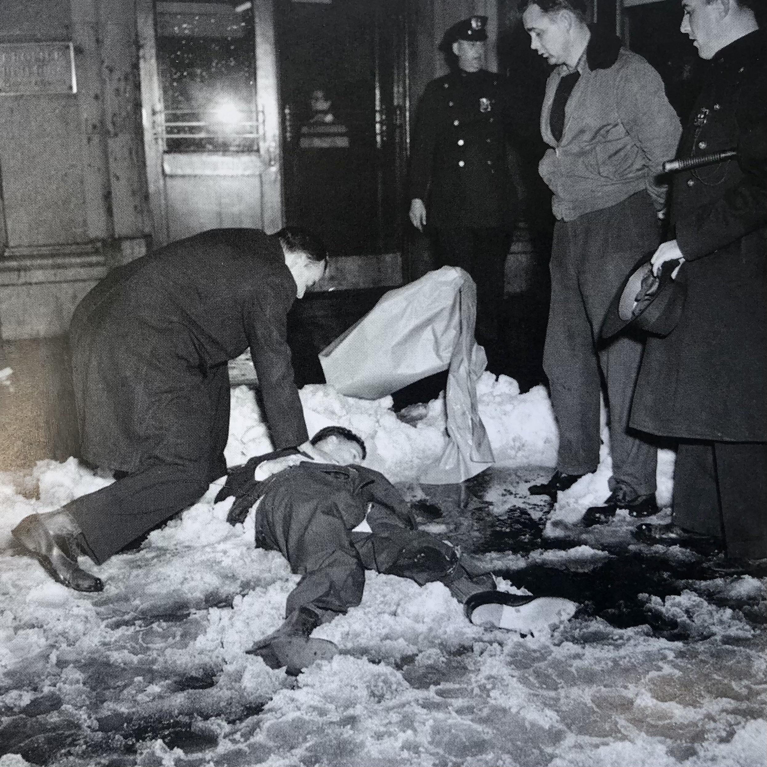 A priest administers last rites to Laurence Duggan, WWII State Dept Head, Soviet spy, after he jumped from the window of his Manhattan office in December 1948.