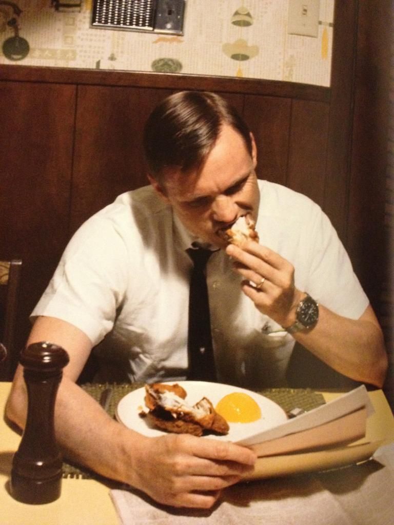Neil Armstrong eating his last breakfast on Earth before leaving for the moon (July 1969)