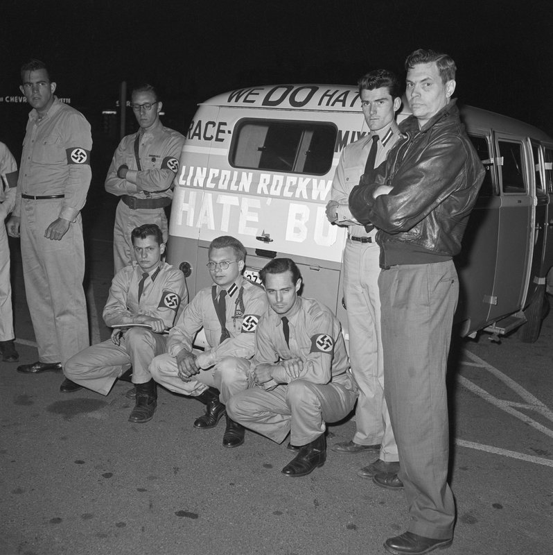 George Lincoln Rockwell (far right) with American Nazi party members, including the man that later killed him, John Patler (kneeling, left), and their Volkswagen hate bus in Virginia, 1961