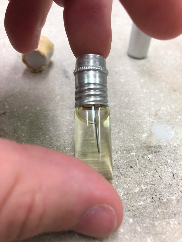 Found this in the machine shop/ science dump of my college has a needle in a glass container in some sort of oil and a glass pipette. Each were found in this metal containers

A: It’s a watch/clockmakers oiling set