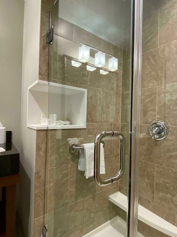 This hotel I’m staying at has the shower shelf accessible from both inside as well as outside