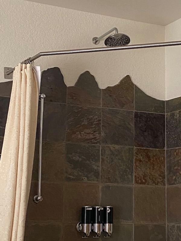 Shower tiles are cut into mountain shapes, in my hotel in a mountainous destination