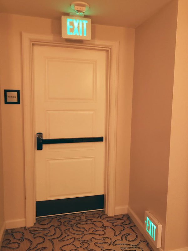 My hotel had Exit signs near the floor, presumably for when you are crawling on the floor to avoid smoke inhalation during a fire