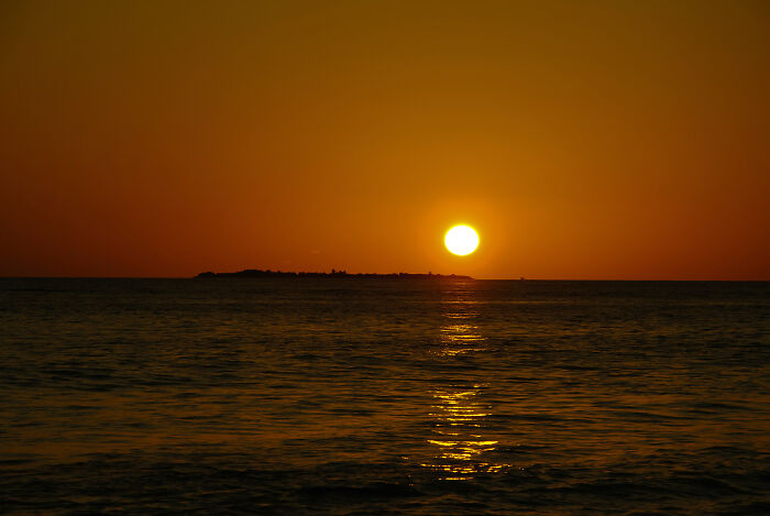 Watching a sunset on the ocean one day when a late teens person asked me why the ocean doesn't put the sun's fire out.