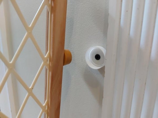 Use bottle lids to hold pressfit baby gates in place.