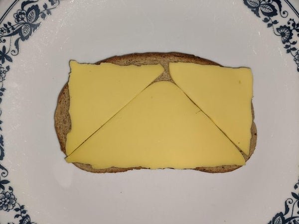 Fold square cheese into triangles to help it fit rectangular bread