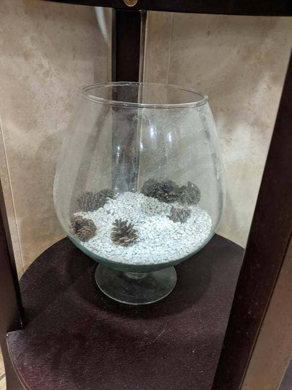 End table décor that looks like turds in kitty litter.