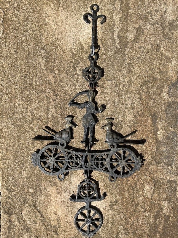 Metal ornament possibly bought in Tunisia or Egypt. Appears to show a person holding a severed head. Kept in a garden for many years

A: It is a Byzantine cross candle holder.