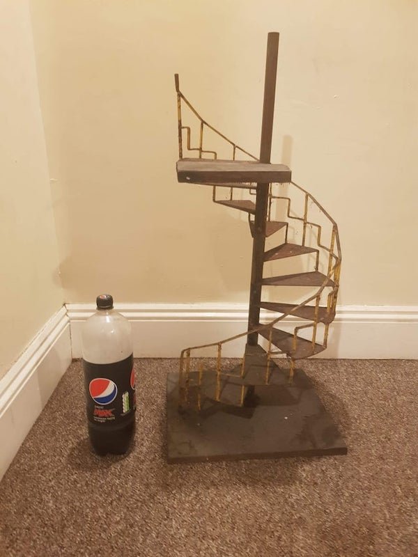 Found in an attic in South Wales. Stairs are metal, top platform is wooden.

A: It’s either a plant holder or part of a dollhouse.