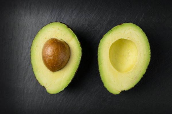 Keeping a pit in your avocado keeps the avocado from browning.

The browning comes from oxygen exposure. Rub a little lemon juice to create a barrier and wrap tight in plastic for best results.