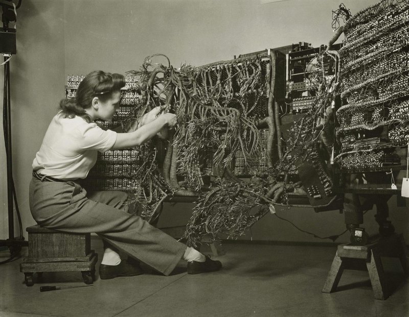 An engineer wiring an early IBM computer, 1958