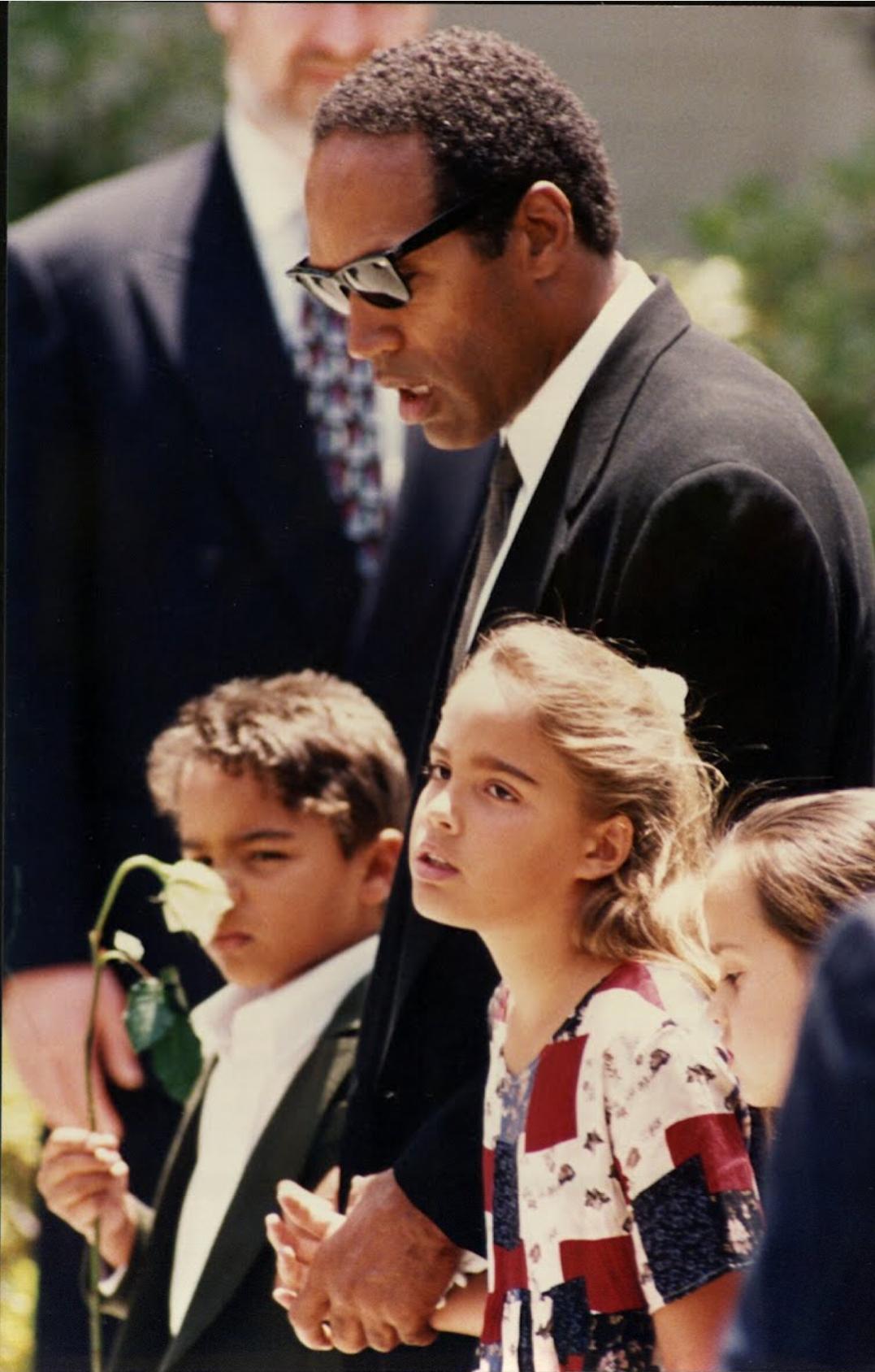 O.J. Simpson with his children at the grave of their murdered mother, Nicole Brown Simpson. 1994