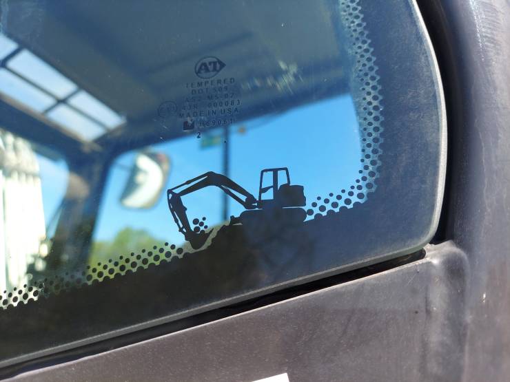 “There's a cute little excavator graphic on the window of this excavator.”