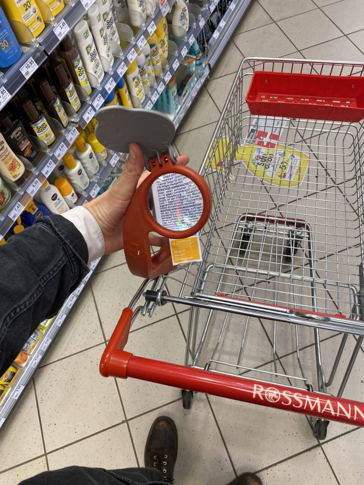 “This shopping cart has a magnifying glass attached to it.”