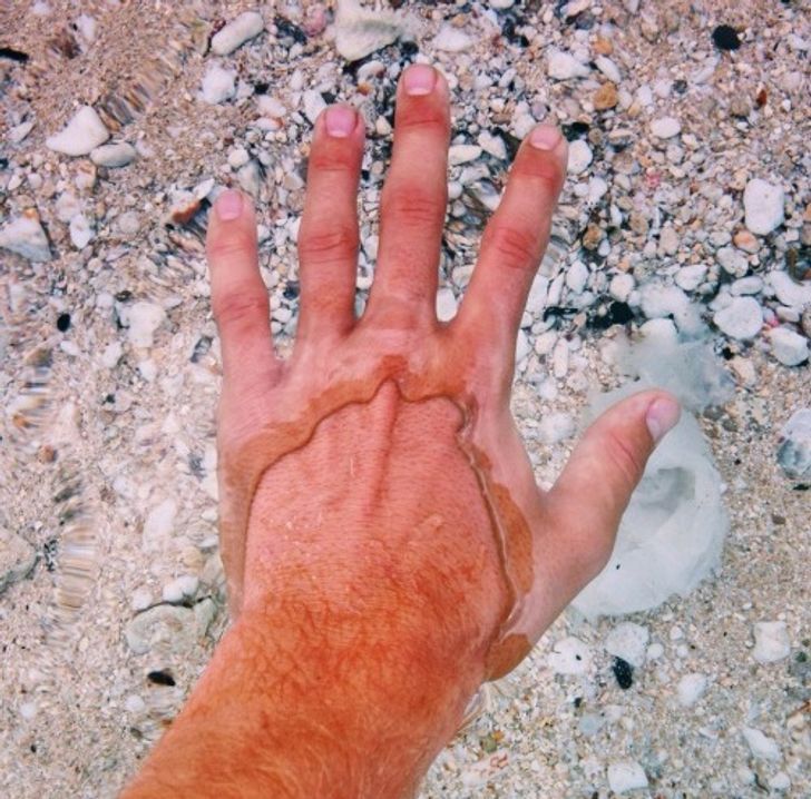 The water is so clear and still that it looks like this man has 2 layers of skin.