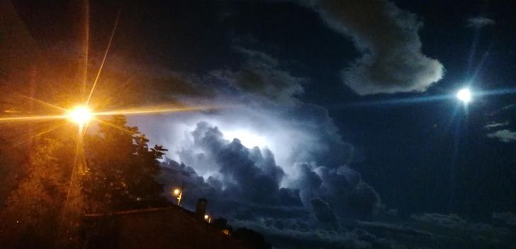 “A full moon on the right side, a street light on the left, and a thunderstorm in between.”