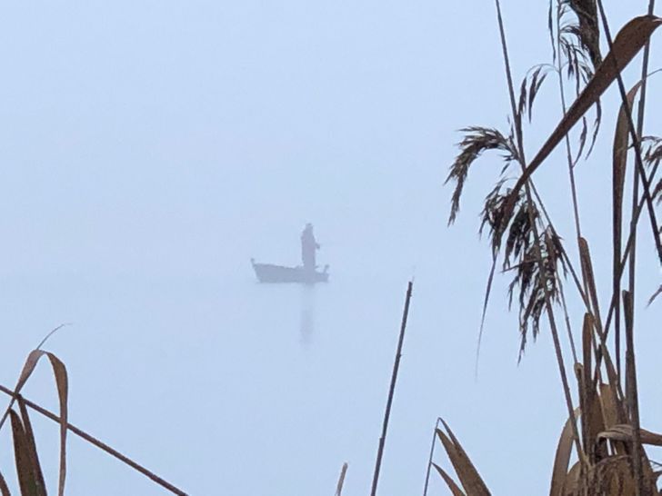 “A guy I saw, fishing in his boat on a very foggy day...”