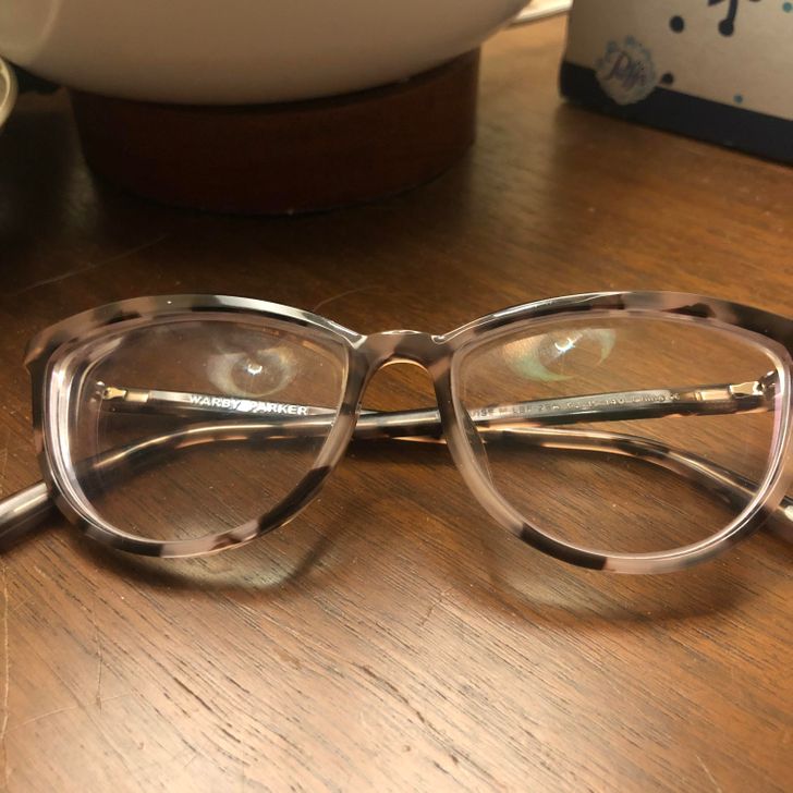 “The reflection of the underside of a lamp in my glasses”