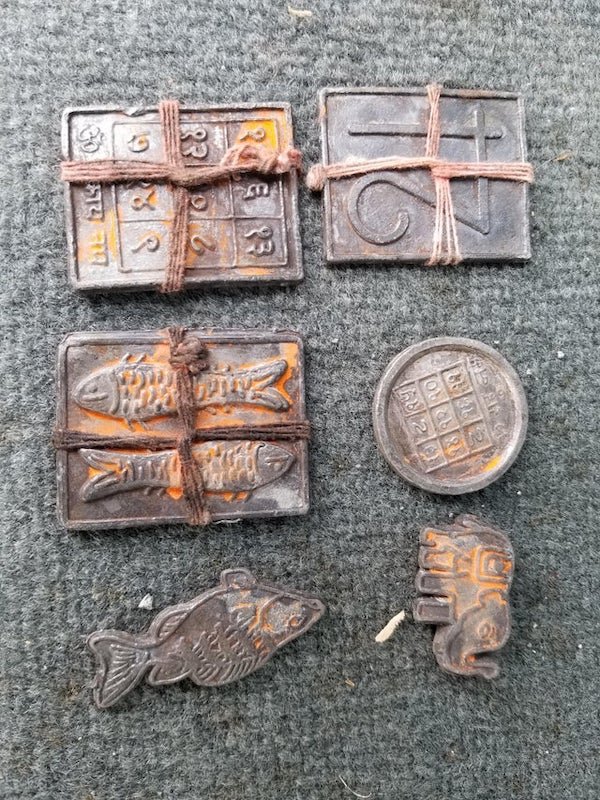 Found these soft metal objects while metal detecting under a pier at low tide.A: They’re Hindu offerings. The symbol on the top-left is Om.