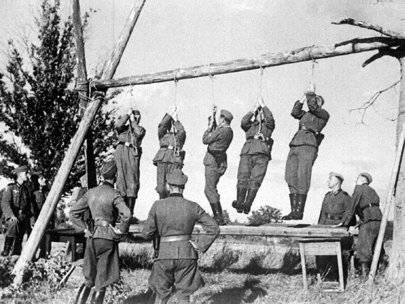 Wehrmacht soldiers testing the strength of the gallows before an execution