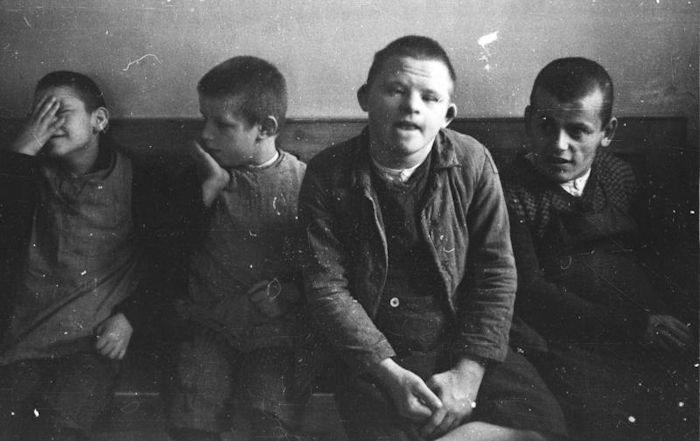 Children with Down syndrome sit at Schönbrunn Psychiatric Hospital, 1934. Mentally challenged children were forcibly sterilized, and were initially taught in separate classrooms, but then considered to be “unteachable.” Later, children like these would be murdered by the Nazis.
