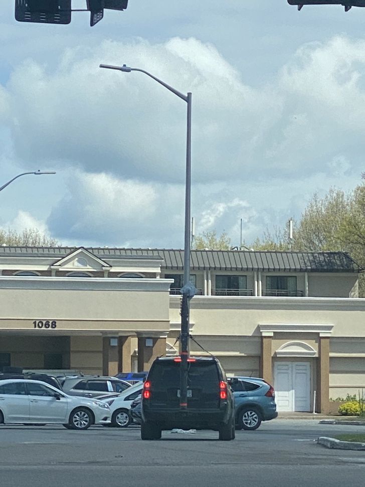 It looks like the car is holding a light post.