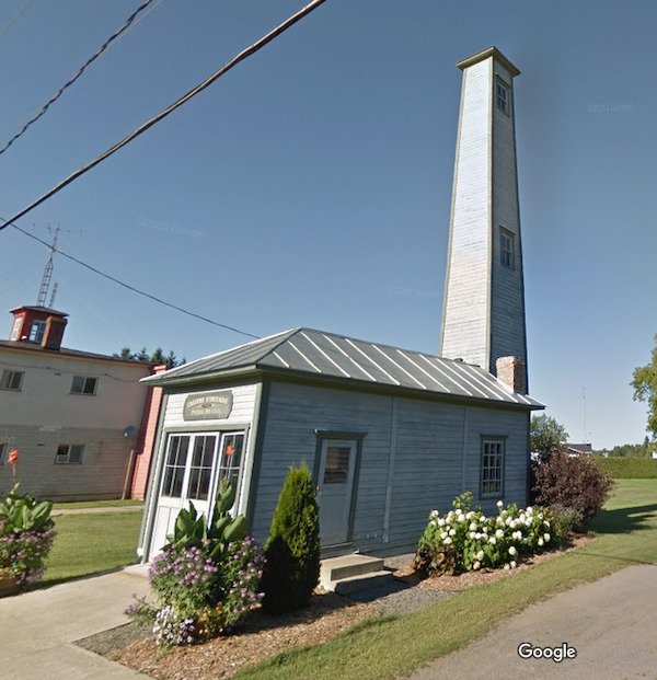 What is this giant tower? It has windows on the side, and it can’t be much wider than a staircase. It is connected to a tiny house labeled ”fire station”. Small town in Quebec, Canada

A: Most likely a hose tower