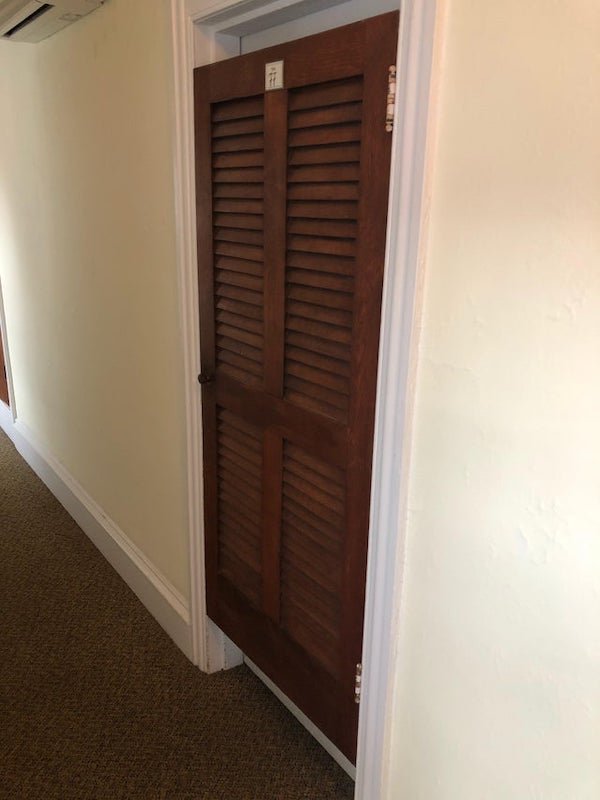 What is the purpose of this door in front of another door leading into my hotel room?

A: Probably a remnant of the days before central heat/AC. Would allow you to open the door for more airflow but it would still afford some privacy.