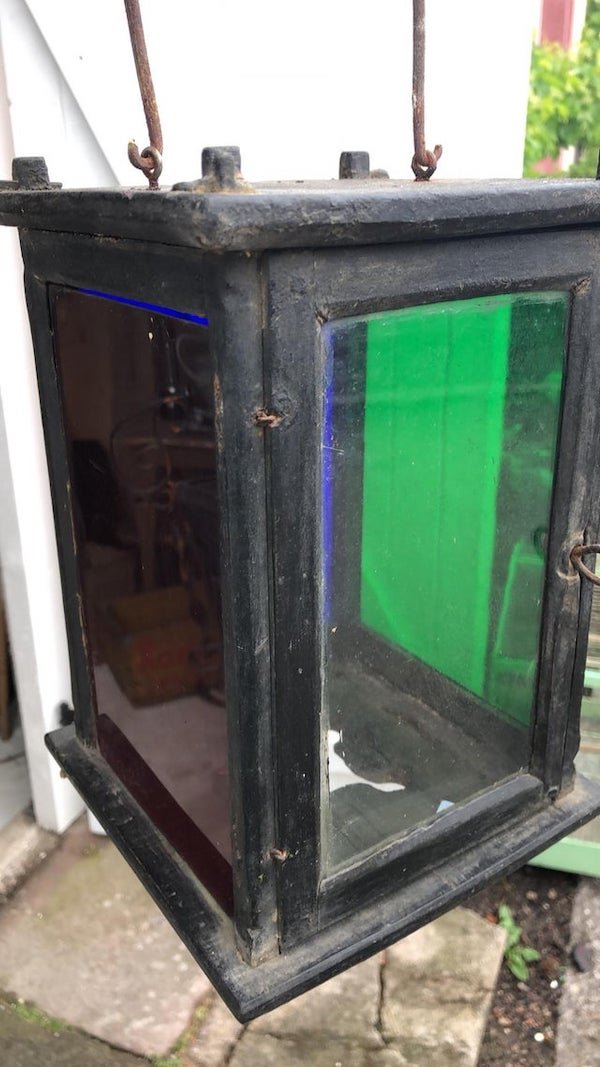 Lantern with 4 sides of differently coloured glass. Green Red White and Blue. Might have been used at a railroad station 