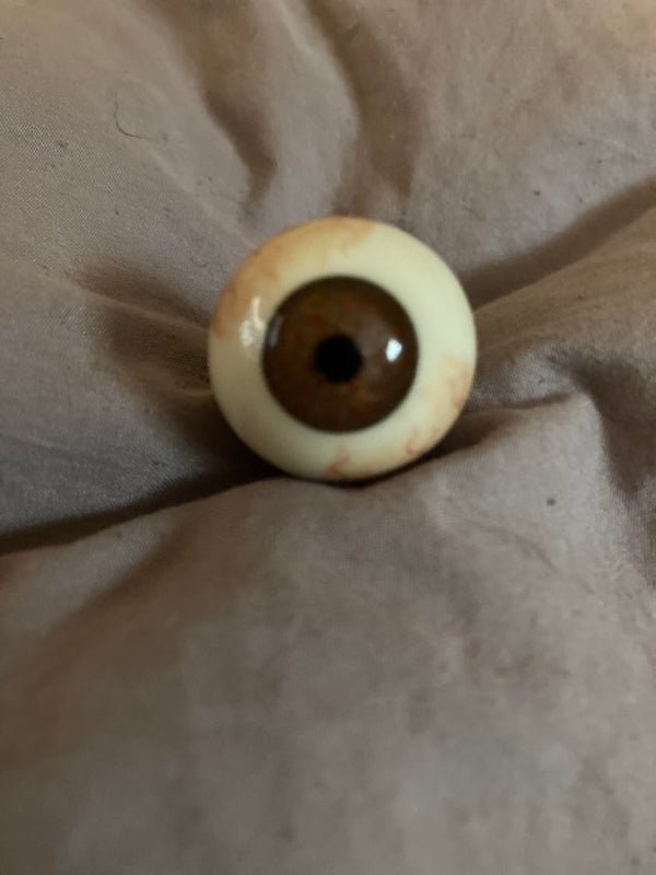 Real life looking eyeball, maybe glass? With 3 holes on the metal piece. Found at a flea market.

A: I have one of those! It’s a promotional key ring for a company that makes glass eyes for taxidermy. I got it at a hunting convention in the 80s.
