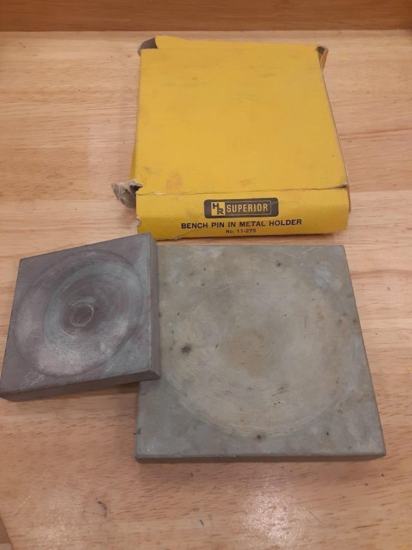 My Metals Professor in college does not know what this thing is. We dont either and he has multiple of different sizes. The box has no info besides what is shown in the photo. It is some kind of ceramic material with an inverted dome in the center. Any help?

A: It is a slate dish for grinding flux. Back in the day, you put a little water in it and rubbed a borax cone in it to make up the day’s flux.