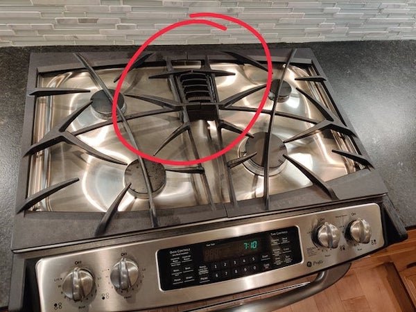 This thing on the stove. It has a burner under it too. The thing can be removed as its own metal piece.

A: It’s an oven vent!
